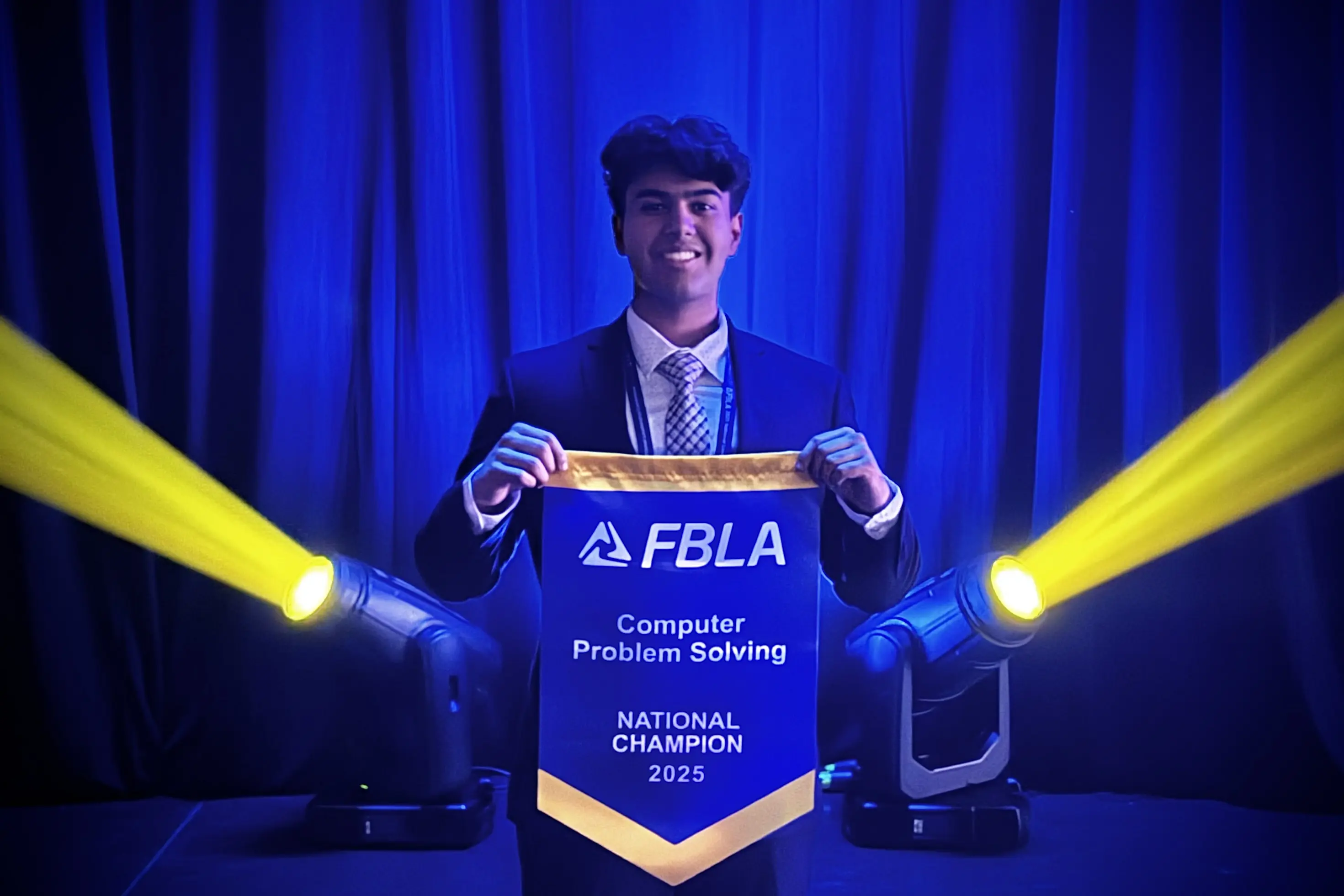 Samarth Bansal holding his National Champion banner in Computer Problem Solving at FBLA NLC